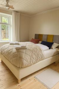 a bedroom with a large bed in a room at Downtown Boutique Apartment in Akureyri
