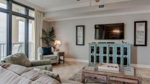 un salon avec un canapé et une télévision dans l'établissement The Oasis Orange Beach 2110, à Orange Beach