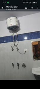 a camera on the wall of a bathroom with a toilet at Hotel vivekanand in Badrīnāth
