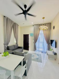 a living room with a couch and a ceiling fan at Laman Kota Pool Homestay in Kota Sarang Semut +10 photos