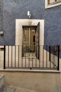 a fence with a door in front of a building at Casa Paulina in Guanajuato