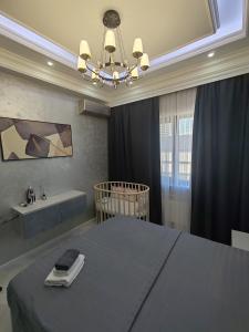 a bedroom with a bed and a bath tub at Tashkent city Gardens E 8-73 in Tashkent