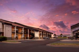 a rendering of a building with a sunset at Quality Inn Madison - Huntsville in Madison
