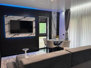 a living room with a couch and a table at HERA Elysium Apartament AFRODITA in Sinaia
