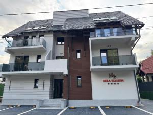 a building with a red sign on it at HERA Elysium Apartament AFRODITA in Sinaia