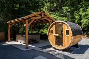 a large wooden circular building with a gazebo at Hot Tub, Sauna, Cold Plunge - 1 mile from Rainier NP - Sleeps 8 in Ashford