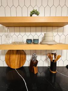 a wooden shelf with plates and utensils on it at Hot Tub, Sauna, Cold Plunge - 1 mile from Rainier NP - Sleeps 8 in Ashford +29 photos