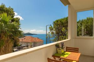 a balcony with a table and a view of the ocean at Apartment Di Maria in Dubrovnik