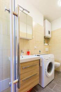 a bathroom with a washing machine and a sink at Apartment Di Maria in Dubrovnik