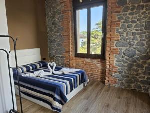 a bedroom with two beds in a brick wall at 2- Atardeceres in Castro-Urdiales