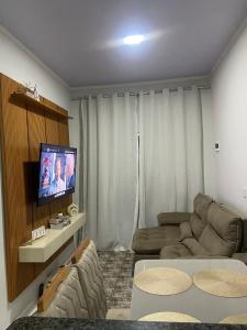 a living room with a couch and a flat screen tv at Rent for COP 30 in Belém! in Castanhal