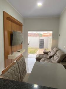 a living room with a couch and a flat screen tv at Rent for COP 30 in Belém! in Castanhal