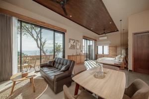 a living room with a couch and a table at Diamond Hill Villa in Labuan Bajo