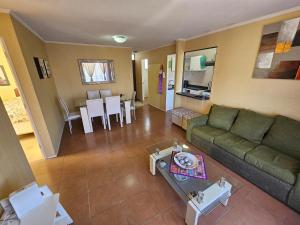 a living room with a couch and a table at Departamento diario en Copiapo en quinto piso in Copiapó