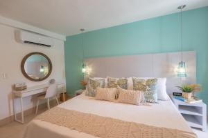 a bedroom with a large bed and a mirror at The beach, my happy place- One bedroom Apartment in Puerto Plata +20 photos