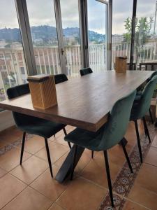 a wooden table and chairs in a room with windows at Rooftop apartment Cannes center - Parking in Cannes +10 photos