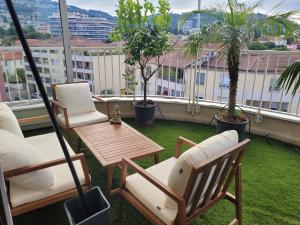 a patio with chairs and a table on a balcony at Rooftop apartment Cannes center - Parking in Cannes