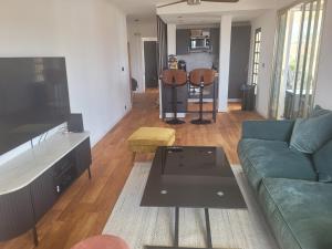 a living room with a couch and a coffee table at Rooftop apartment Cannes center - Parking in Cannes