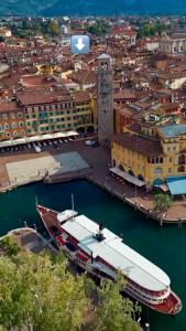 arial view of a city with a boat in the water at Casa Bors in Riva del Garda