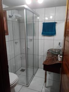 a bathroom with a shower with a sink and a toilet at Pousada do Aconchego in São Salvador +6 photos