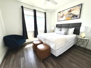 a bedroom with a large bed and a blue chair at Beautiful Apartment close to Attractions in Kissimmee