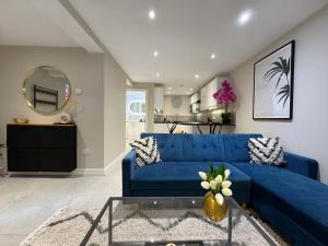 a living room with a blue couch and a table at Central Bury Apartment with Private Entrance in Bury Saint Edmunds