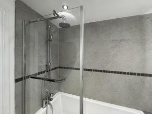 a shower with a glass door in a bathroom at Central Bury Apartment with Private Entrance in Bury Saint Edmunds +6 photos