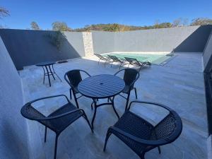 a group of tables and chairs on a patio at FLATs UTOPIA in Capitólio