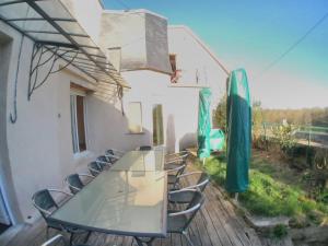 a glass table and chairs on a deck at la roche coeur in Vouvray