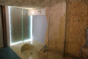 a bathroom with a tub in the corner of a room at la roche coeur in Vouvray +30 photos