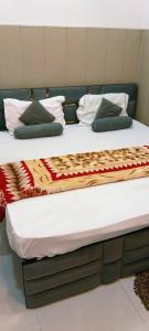 two beds with pillows and a blanket on them at Dev PG Stay in Vrindāvan +92 photos