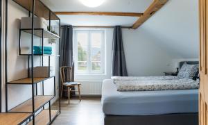 a bedroom with a bed and a window at Ferienhaus Kluser in Oberriet