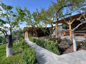 a house with a walkway in front of a yard at Garden House in Yerevan