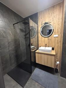 a bathroom with a sink and a shower at Apartament Grafitowy in Nysa +25 photos