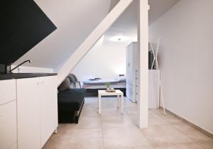 a white room with a bed and a table at Lipno -Slupečná in Kramolín +1 photo