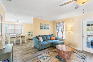 a living room with a couch and a table at Mermaid Landing - St Joe Beach by Coastline Vacation Rentals in Saint Joe Beach +27 photos