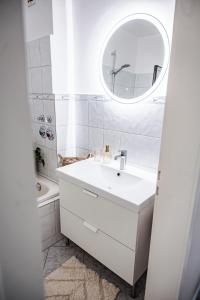 a white bathroom with a sink and a mirror at Cozybude #mitliebezumdetail in Appen +48 photos