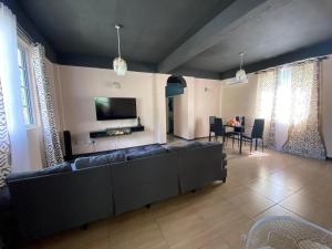 a living room with a large couch and a table at Kay-La Vie in Roseau