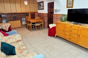 a living room with a couch and a flat screen tv at Casa Rural con Patio y Barbacoa en Pinoso 