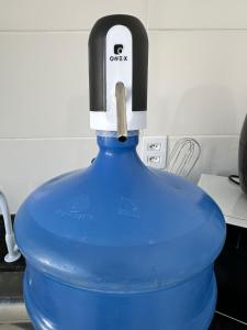 a large blue vase with a knife sticking out of it at Casa para 5 pessoas - Perto de Tudo in Montes Claros