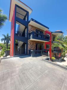 a large building with a staircase in front of it at Eskapaz luxury in Sosua