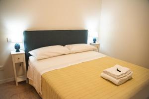 a bedroom with a large bed with two night stands at All'ombra del Duomo in Ascoli Piceno +11 photos