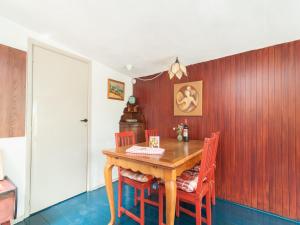a dining room with a wooden table and chairs at Holiday Home Bergen near Forest & Beach in Bergen