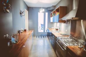 cocina con encimeras de madera y horno con fogones en La terrasse de la comédie, en Montpellier