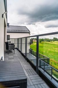 a balcony with a view of a field at Morze Apartamentów Apartament West Łeba A19 in Łeba