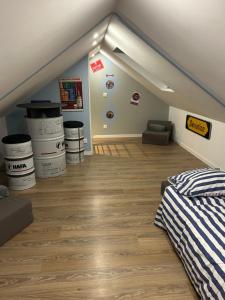 a attic room with a bed and a couch at Joe bar stud in Gonnetot