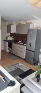 a kitchen with a stainless steel refrigerator in a room at Apparemment deux chambres in La Ferté-sous-Jouarre