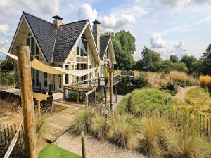 a house with a slide in a garden at Holiday Home with bubble bath in Noordwijk in Noordwijk