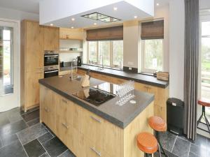 a kitchen with a large island with a counter top at Holiday Home with bubble bath in Noordwijk in Noordwijk