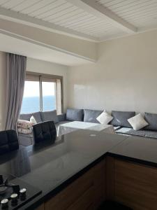 a living room with a bed and a couch at Résidence 7 vagues in Oualidia +19 photos
